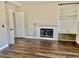 Cozy living room featuring wood floors, a fireplace, and built-in shelving for storage at 8397 San Ramon Dr, Las Vegas, NV 89147