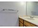 Bathroom vanity with wood cabinets, single sink, and white countertop at 875 Rhinegold Way, Las Vegas, NV 89110