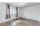Bright bedroom with hardwood floors and gray curtains at 875 Rhinegold Way, Las Vegas, NV 89110