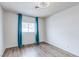 Bedroom featuring hardwood floors, white walls, and blue curtains at 875 Rhinegold Way, Las Vegas, NV 89110