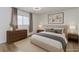 A bright bedroom features neutral walls and carpet, with contemporary furniture at 875 Rhinegold Way, Las Vegas, NV 89110