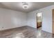 A bright bedroom features hardwood floors and leads to an attached bath at 875 Rhinegold Way, Las Vegas, NV 89110