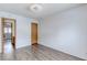 Bedroom with hardwood floors, light walls, and wood door at 875 Rhinegold Way, Las Vegas, NV 89110