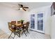 Bright dining room with a view of the back patio and wood table with four chairs at 875 Rhinegold Way, Las Vegas, NV 89110