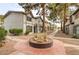 Charming townhouse complex with mature trees and landscaping along a walkway at 875 Rhinegold Way, Las Vegas, NV 89110