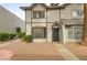 Charming two-story townhome featuring a gray exterior with decorative trim and a well-maintained front yard landscape at 875 Rhinegold Way, Las Vegas, NV 89110