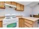 Kitchen with white gas range stove, wood counters, and adjacent dining area at 875 Rhinegold Way, Las Vegas, NV 89110