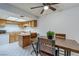 Kitchen with wood cabinets, white appliances, and a view of the wood table with chairs at 875 Rhinegold Way, Las Vegas, NV 89110