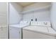 Functional laundry room with a side by side washer and dryer and shelf for storage at 875 Rhinegold Way, Las Vegas, NV 89110