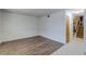 Spacious living room with wood-look floors, leading to a staircase with tiled landing at 875 Rhinegold Way, Las Vegas, NV 89110