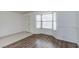 Open living room features durable wood-look flooring and a bright bay window at 875 Rhinegold Way, Las Vegas, NV 89110