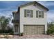 Charming two-story home with neutral stucco, a tiled roof, and well-maintained front yard landscaping at 9243 Charmillin Ct, Las Vegas, NV 89148