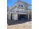 New construction home featuring a two-car garage and scaffolding, awaiting exterior finishing at 9249 Charmillin Ct, Las Vegas, NV 89148