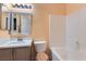 Cozy bathroom featuring a single sink vanity, a toilet, and a bathtub with a white tile surround at 9303 Gilcrease Ave # 1002, Las Vegas, NV 89149