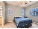 Cozy bedroom with carpet floors and natural light from the windows at 9303 Gilcrease Ave # 1002, Las Vegas, NV 89149