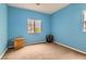 Bright bedroom with blue walls, a large window, and neutral carpet at 9303 Gilcrease Ave # 1002, Las Vegas, NV 89149