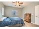 Relaxing bedroom with a ceiling fan, window, and dresser at 9303 Gilcrease Ave # 1002, Las Vegas, NV 89149