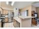 Open kitchen with stone countertops, stainless steel appliances, and ample cabinet space at 9303 Gilcrease Ave # 1002, Las Vegas, NV 89149