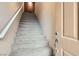 The staircase leads to the upper level, showcasing modern design, neutral tones, and a welcoming atmosphere at 9303 Gilcrease Ave # 1002, Las Vegas, NV 89149