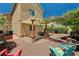An inviting backyard boasts a covered patio with seating, a well-manicured desert landscape, and additional patio space at 9370 Corkfish St, Las Vegas, NV 89178