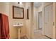 Functional bathroom featuring a pedestal sink and a decorative mirror at 9370 Corkfish St, Las Vegas, NV 89178