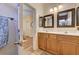 Bathroom features a double sink vanity with framed mirrors, updated fixtures, and a view into the adjacent bedroom at 9370 Corkfish St, Las Vegas, NV 89178