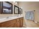 Bathroom features a double sink vanity with framed mirrors, a towel rack, and updated fixtures for added convenience at 9370 Corkfish St, Las Vegas, NV 89178