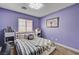 Bright bedroom with lavender walls, window with blinds and comfortable looking bed at 9370 Corkfish St, Las Vegas, NV 89178