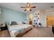 Bright and cozy bedroom featuring large bed, shelves and ceiling fan at 9370 Corkfish St, Las Vegas, NV 89178