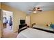 Cozy bedroom featuring twin beds, ceiling fan, and a walk-in closet for ample storage at 9370 Corkfish St, Las Vegas, NV 89178