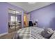 Bedroom with lavender walls, mirrored closet, and a study desk at 9370 Corkfish St, Las Vegas, NV 89178