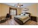 Comfortable bedroom with a king-sized bed, soft lighting, and a ceiling fan at 9370 Corkfish St, Las Vegas, NV 89178