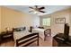 Comfortable ' bedroom with two twin beds, ceiling fan, and carpeted floor providing ample room for relaxation and play at 9370 Corkfish St, Las Vegas, NV 89178