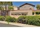 The Arlington West community entrance is marked by a stone sign surrounded by lush, green landscaping at the entrance at 9370 Corkfish St, Las Vegas, NV 89178