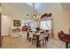 Bright dining area boasts an elegant chandelier, modern furnishings, and an open flow into the kitchen at 9370 Corkfish St, Las Vegas, NV 89178