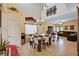 Open-concept dining area features soaring ceilings, elegant chandelier, and seamless flow into the living space at 9370 Corkfish St, Las Vegas, NV 89178