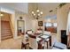 Inviting dining room with chandelier, staircase, and view into the kitchen at 9370 Corkfish St, Las Vegas, NV 89178