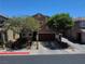 A two-story home with mature shade trees, and well-kept landscaping, enhances the property's curb appeal at 9370 Corkfish St, Las Vegas, NV 89178