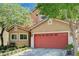 A cozy home with a two-car garage is enhanced by mature trees, lush landscaping, and a quaint bench at 9370 Corkfish St, Las Vegas, NV 89178