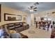 Open-concept living room with tile flooring, comfortable seating, and views to the kitchen at 9370 Corkfish St, Las Vegas, NV 89178