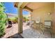 Covered patio with outdoor seating, grill, and lush landscaping at 9370 Corkfish St, Las Vegas, NV 89178