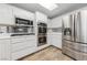 Bright kitchen features stainless steel appliances, white cabinets, and wood-look flooring at 9917 Arbuckle Dr, Las Vegas, NV 89134