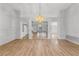 Spacious living room featuring wood floors, a modern chandelier, and lots of natural light at 9917 Arbuckle Dr, Las Vegas, NV 89134