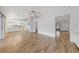 Open-concept living area next to a spacious kitchen, bathed in natural light and with wood-look floors at 9917 Arbuckle Dr, Las Vegas, NV 89134