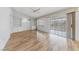 The bright living room offers built-in shelving, sliding glass doors, and wood-look flooring at 9917 Arbuckle Dr, Las Vegas, NV 89134