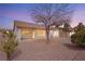 The backyard featuring desert landscaping and an extended covered patio offers a private retreat at 10309 Georgetown Pl, Las Vegas, NV 89134