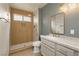 Modern bathroom features dual sinks, stylish mirrors, and a walk-in shower at 10309 Georgetown Pl, Las Vegas, NV 89134