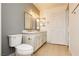 Well-lit bathroom with dual sinks, modern fixtures, and wood-look flooring at 10309 Georgetown Pl, Las Vegas, NV 89134