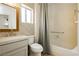 Cozy bathroom featuring patterned wall, toilet, vanity, and shower with curtain at 10309 Georgetown Pl, Las Vegas, NV 89134