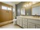 Modern bathroom features dual sinks, stylish mirrors, and a walk-in shower at 10309 Georgetown Pl, Las Vegas, NV 89134